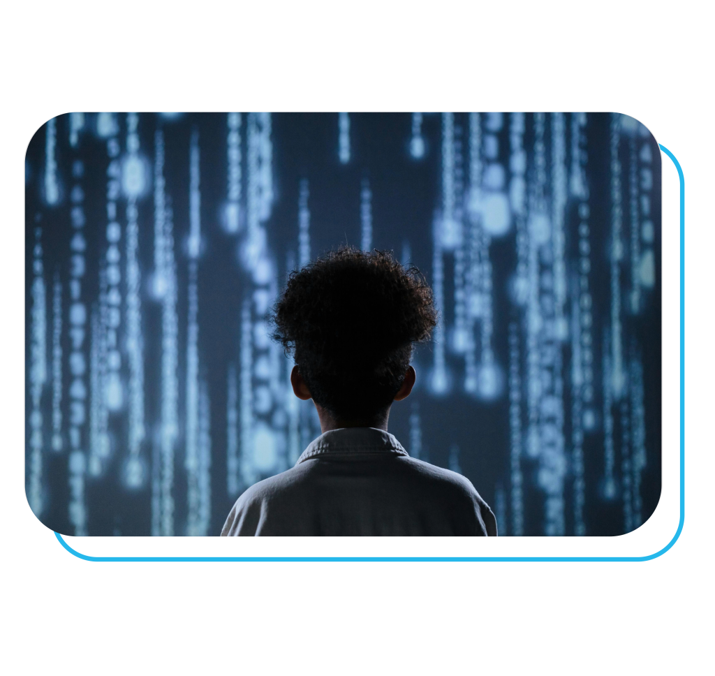 A child standing in front of a digital screen filled with glowing data streams, symbolizing the intersection of emotional intelligence and artificial intelligence in the modern classroom.