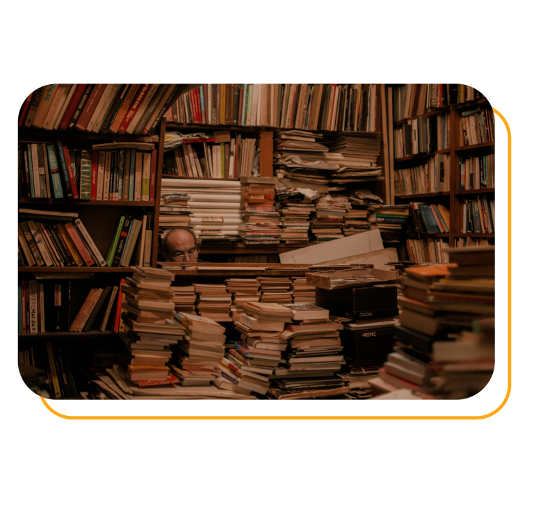 A room overwhelmed with books and papers stacked high, representing hoarding behavior.